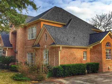 metal roofing pictures brick house|brick house with black shingles.